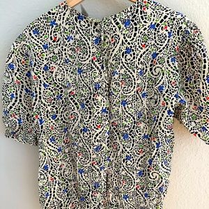 Beautiful vintage shirt size 12. Buttons in the back.